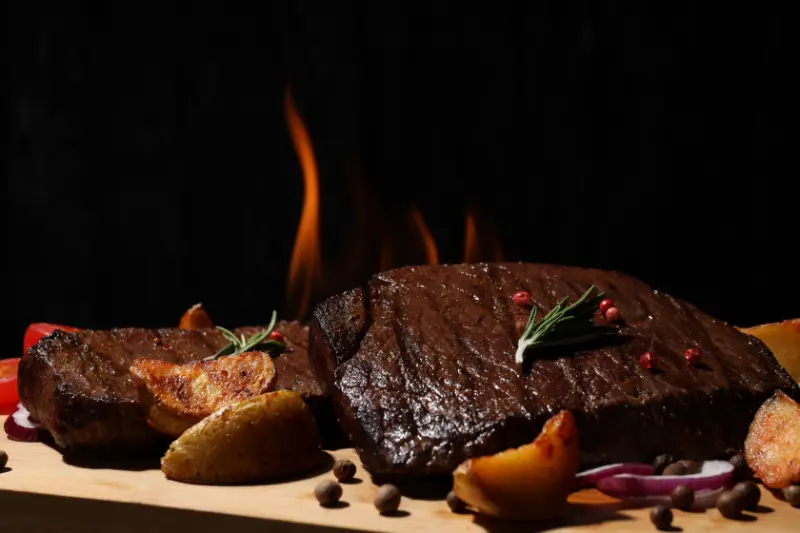 concept-of-tasty-food-with-beef-steaks-on-dark-bac-2025-03-24-11-26-43-utc